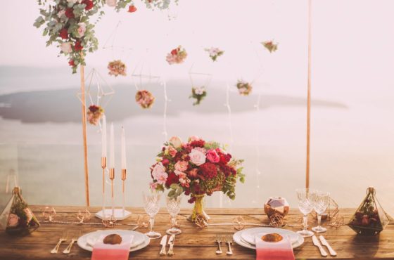 pink-and-red-roses-centerpiece-near-silverwares